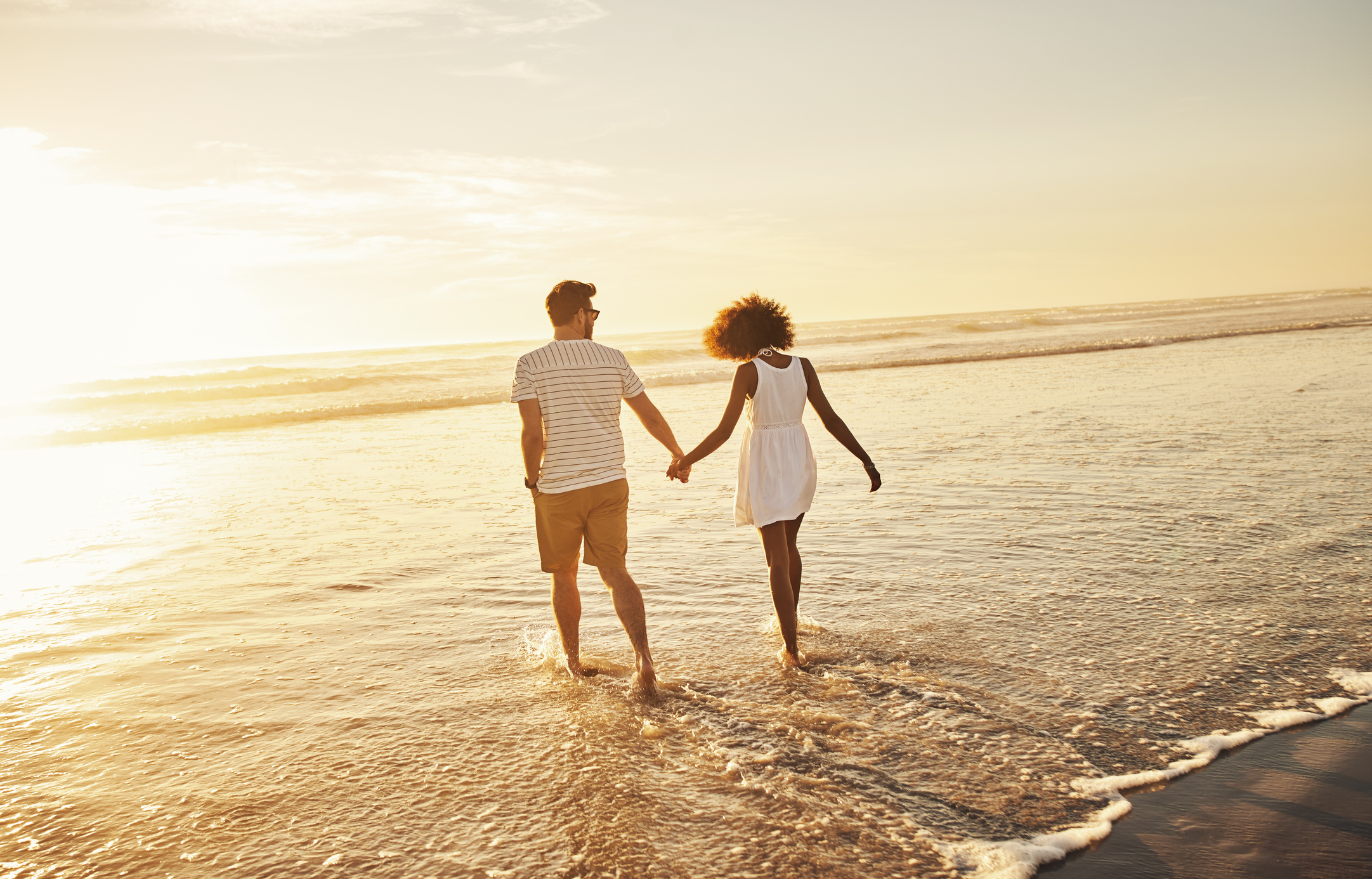 Shot of a young couple bonding at the beach